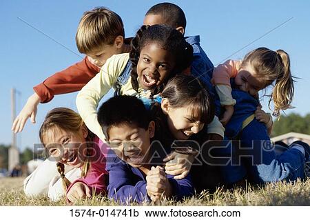 Group of children playing on a lawn View Large Photo Image Stock Image - Group of children playing on a lawn. Fotosearch