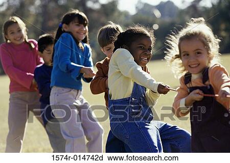 Group of children playing tug-of-war View Large Photo Image Stock Image - Group of children playing tug-of-war. Fotosearch