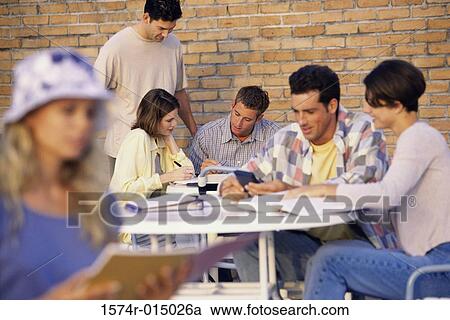 Stock Image - Group of people studying on a college campus. Fotosearch