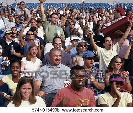 Stock Image - Group of spectators in a stadium cheering. Fotosearch