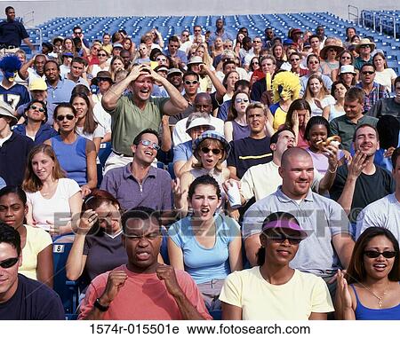 Group of spectators in a stadium cheering View Large Photo Image Stock Image - Group of spectators in a stadium cheering. Fotosearch
