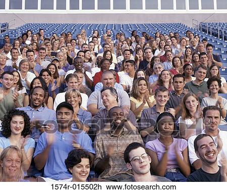 Group of spectators in a stadium cheering View Large Photo Image Stock Image - Group of spectators in a stadium cheering. Fotosearch