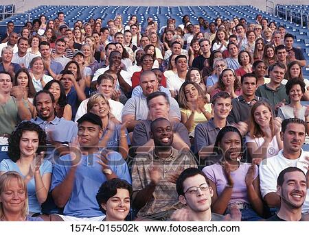 Group of spectators in a stadium cheering View Large Photo Image Stock Image - Group of spectators in a stadium cheering. Fotosearch