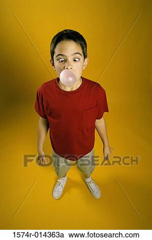 High angle view of a boy blowing a bubble View Large Photo Image Stock Image - High angle view of a boy blowing a bubble. Fotosearch
