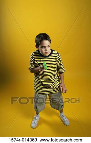 High angle view of a boy holding a toy gun View Large Photo Image Stock Photo - High angle view of a boy holding a toy gun. Fotosearch