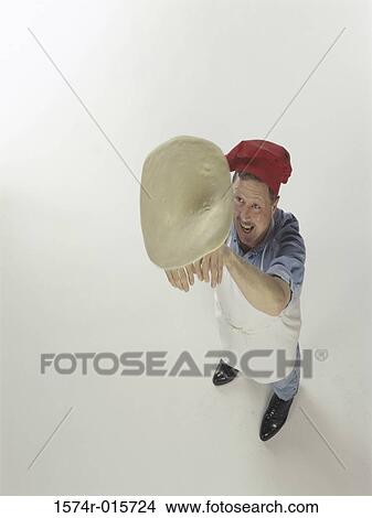 High angle view of a chef tossing pizza dough View Large Photo Image Picture - High angle view of a chef tossing pizza dough. Fotosearch