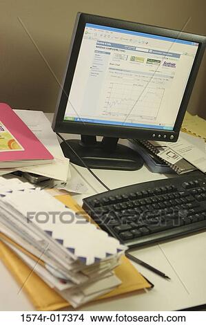 High angle view of a desktop pc with a stack of envelopes on a table View Large Photo Image Picture - High angle view of a desktop pc with a stack of envelopes on a table. Fotosearch