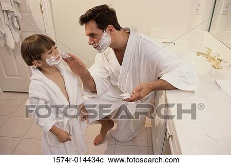 High angle view of a father applying shaving cream to his son's face View Large Photo Image Stock Image - High angle view of a father applying shaving cream to his son's face. Fotosearch