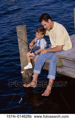 High angle view of a father teaching his son to fish View Large Photo Image Stock Image - High angle view of a father teaching his son to fish. Fotosearch