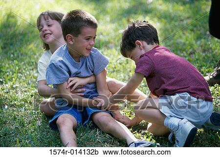 High angle view of a girl and two boys playing on a lawn View Large Photo Image Stock Image - High angle view of a girl and two boys playing on a lawn. Fotosearch