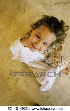 High angle view of a girl smiling View Large Photo Image Stock Image - High angle view of a girl smiling. Fotosearch
