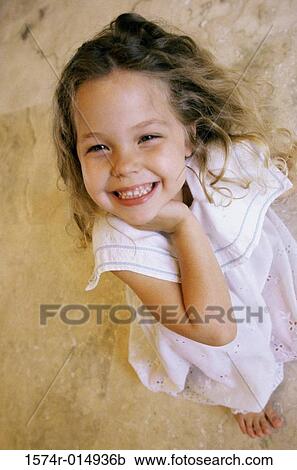 Stock Image - High angle view of a girl smiling. Fotosearch