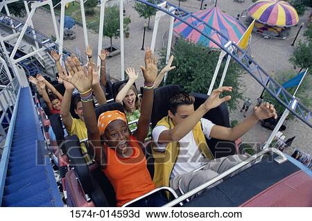 Stock Image - High angle view of a group of people on a rollercoaster. Fotosearch