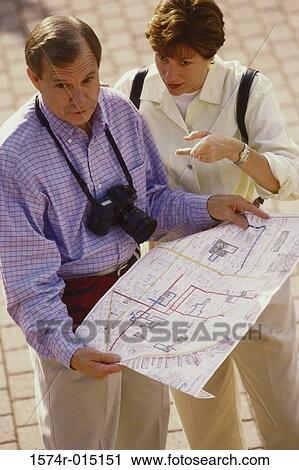 Stock Image - High angle view of a mid adult couple reading a map. Fotosearch