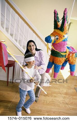 High angle view of a mother helping her daughter hit a pinata View Large Photo Image Stock Photograph - High angle view of a mother helping her daughter hit a pinata. Fotosearch