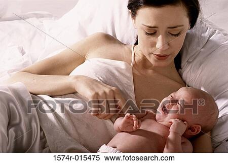 High angle view of a mother lying in bed with her son View Large Photo Image Stock Photography - High angle view of a mother lying in bed with her son. Fotosearch