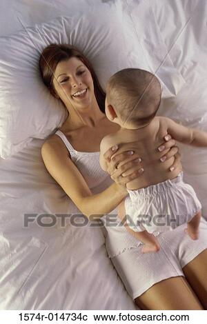 High angle view of a mother playing with her baby boy View Large Photo Image Stock Image - High angle view of a mother playing with her baby boy. Fotosearch