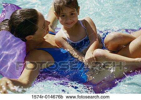 High angle view of a mother with her daughter on a pool raft in a swimming pool View Large Photo Image Stock Image - High angle view of a mother with her daughter on a pool raft in a swimming pool. Fotosearch