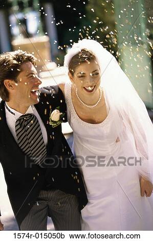 Stock Image - High angle view of a newlywed couple laughing. Fotosearch