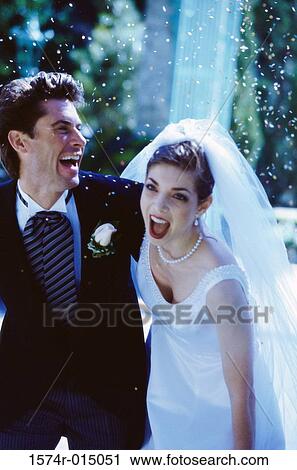 Stock Image - High angle view of a newlywed couple laughing. Fotosearch