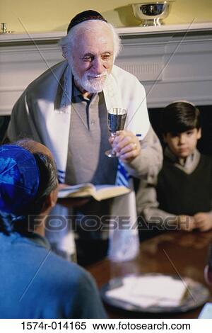 High angle view of a rabbi holding a goblet at a Hanukkah ceremony View Large Photo Image Stock Photography - High angle view of a rabbi holding a goblet at a Hanukkah ceremony. Fotosearch