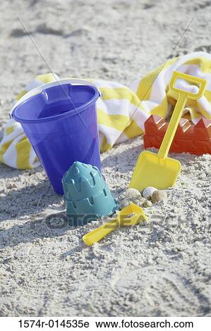 High angle view of a sand pail and a shovel on the beach View Large Photo Image Stock Image - High angle view of a sand pail and a shovel on the beach. Fotosearch