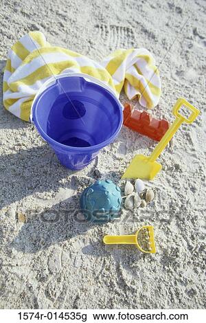 High angle view of a sand pail and a shovel on the beach View Large Photo Image Stock Image - High angle view of a sand pail and a shovel on the beach. Fotosearch