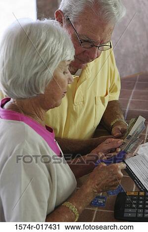 High angle view of a senior couple destroying credit cards View Large Photo Image Stock Image - High angle view of a senior couple destroying credit cards. Fotosearch