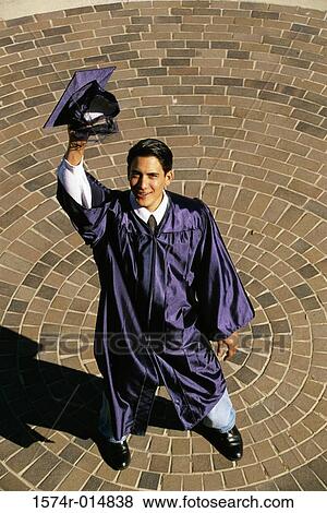High angle view of a teenage graduate boy raising his mortarboard View Large Photo Image Stock Photo - High angle view of a teenage graduate boy raising his mortarboard. Fotosearch