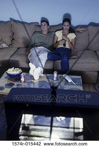 High angle view of a young couple watching television View Large Photo Image Stock Image - High angle view of a young couple watching television. Fotosearch