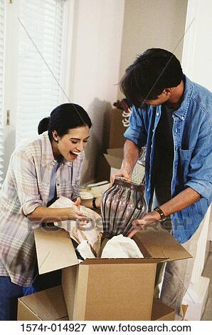 High angle view of a young couple unpacking in their new house View Large Photo Image Stock Photo - High angle view of a young couple unpacking in their new house. Fotosearch