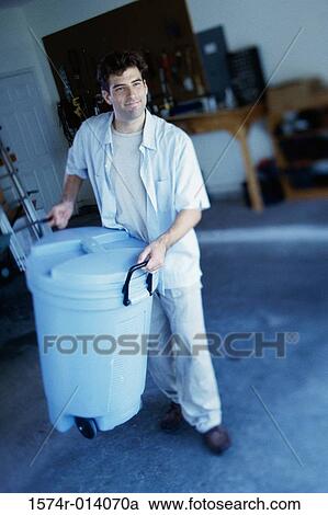 High angle view of a young man carrying a trash can View Large Photo Image Stock Image - High angle view of a young man carrying a trash can. Fotosearch