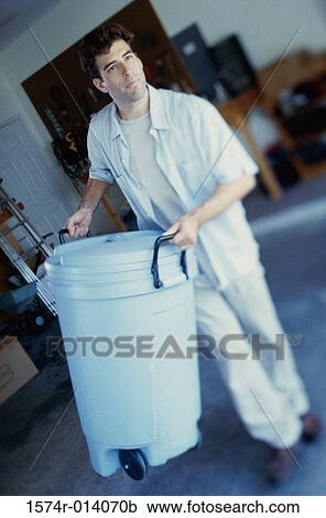 High angle view of a young man carrying a trash can View Large Photo Image Stock Image - High angle view of a young man carrying a trash can. Fotosearch