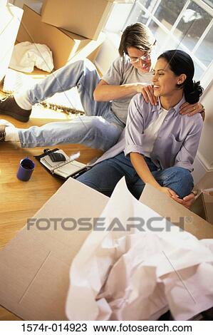 Stock Image - High angle view of a young man massaging a young woman's shoulders. Fotosearch