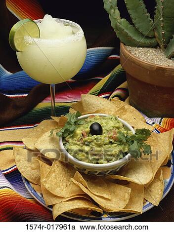 Stock Image - High angle view of guacamole with tortilla chips. Fotosearch