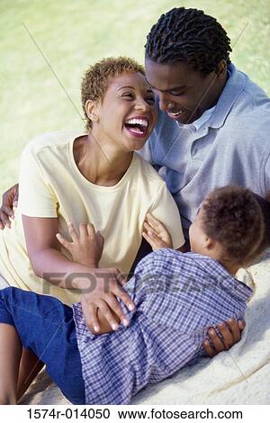 Stock Image - High angle view of parents and their son smiling. Fotosearch