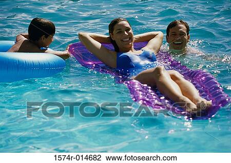 High angle view of parents and their son in a swimming pool View Large Photo Image Stock Image - High angle view of parents and their son in a swimming pool. Fotosearch
