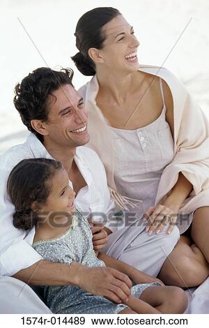 High angle view of parents and their daughter smiling on the beach View Large Photo Image Stock Photo - High angle view of parents and their daughter smiling on the beach. Fotosearch