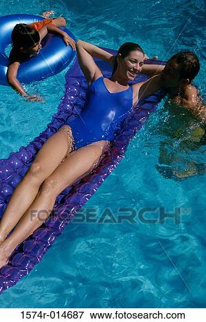 High angle view of parents and their son in a swimming pool View Large Photo Image Stock Photo - High angle view of parents and their son in a swimming pool. Fotosearch