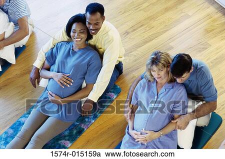 High angle view of pregnant wives with their husbands in a prenatal class View Large Photo Image Stock Image - High angle view of pregnant wives with their husbands in a prenatal class. Fotosearch