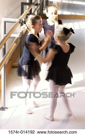 Stock Image - High angle view of three ballerinas standing together. Fotosearch