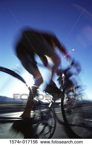 Low angle view of a cyclist on a racing bike View Large Photo Image Stock Photograph - Low angle view of a cyclist on a racing bike. Fotosearch