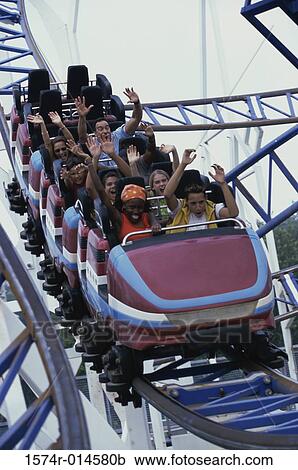 Low angle view of a group of people on a rollercoaster View Large Photo Image Stock Image - Low angle view of a group of people on a rollercoaster. Fotosearch