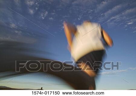 Stock Image - Low angle view of a person jogging. Fotosearch