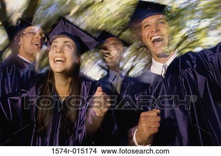Picture - Low angle view of college students celebrating their graduation. Fotosearch