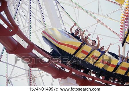 Low angle view of five people on a rollercoaster View Large Photo Image Stock Image - Low angle view of five people on a rollercoaster. Fotosearch