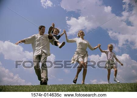 Low angle view of parents swinging their son View Large Photo Image Stock Image - Low angle view of parents swinging their son. Fotosearch