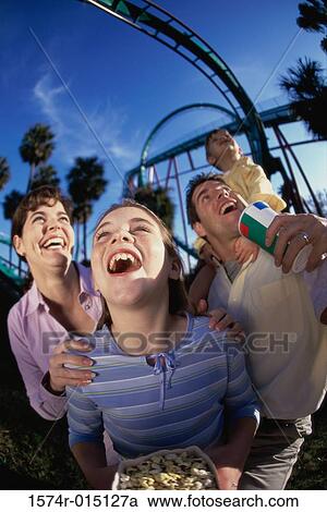Low angle view of parents with their son and daughter in an amusement park View Large Photo Image Stock Image - Low angle view of parents with their son and daughter in an amusement park. Fotosearch