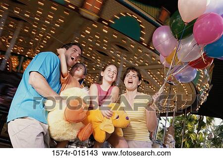 Low angle view of parents with their son and daughter in an amusement park View Large Photo Image Stock Image - Low angle view of parents with their son and daughter in an amusement park. Fotosearch