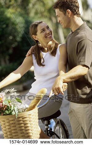 Stock Photo - Mid adult couple looking at each other. Fotosearch
